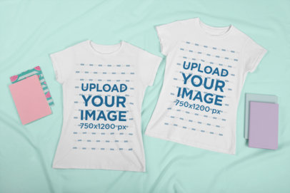Mockup of Two Matching T-Shirts Placed Next to Some Diaries 