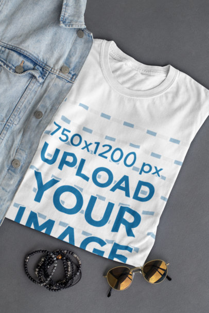 Mockup of a Folded T-Shirt Placed Next to Some Sunglasses 