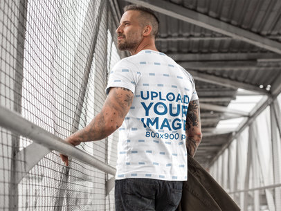 Back Shot of a Man Wearing a Sublimated Tee Mockup Walking on a Bridge