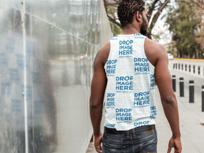 Back Shot of a Man Wearing a Sublimated Heathered Tank Top Mockup Walking on the Street