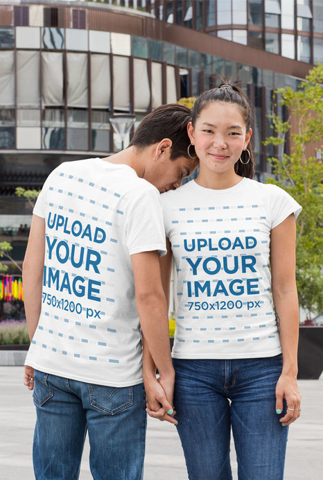 Mockup of a Couple Wearing T-Shirts in the City