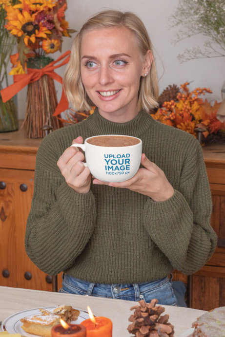 Mockup of a Woman Sipping on Her 24 oz Mug at a Thanksgiving Dinner
