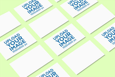 Mockup Featuring Several Business Cards Aligned over a Solid Color Surface 