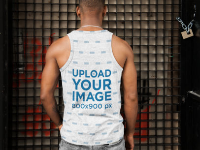 Back Shot of a Man Wearing an All-Over Tank Top Mockup Facing a Metal Door