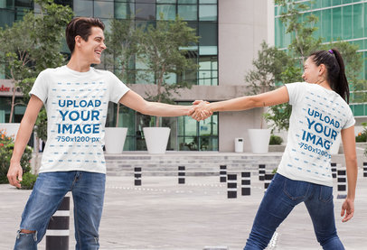 Mockup of a Couple Wearing Matching T-Shirts and Playing Around 