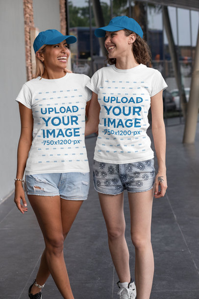 Mockup of Two Best Friends Wearing Matching T-Shirts in the Street
