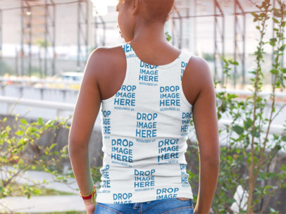 Back of a Woman Wearing a Sublimated Tank Top Mockup while on the Street