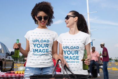 Mockup of Two Women Wearing Crewneck T-Shirts and Drinking at a Tailgate