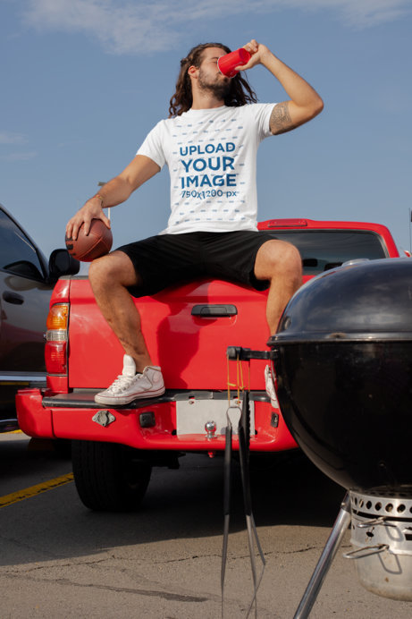 Mockup of a Tattooed Man with a Crewneck T-Shirt at a Tailgate Party 