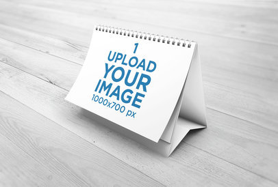 Mockup of a Desk Calendar on a Light-Color Wooden Surface