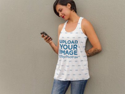Tank Top Mockup of a Tattooed Woman Texting on her Phone