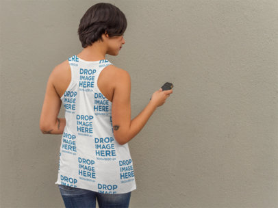 Back of a Girl Wearing a Sublimated Tank Top Mockup Checking her Phone a9240b
