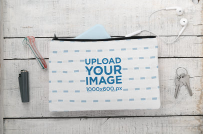 Mockup of a Pouch Laying Flat on a Wooden Surface with Cannabis Accessories 
