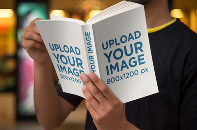 Book Cover Mockup Featuring a Man Reading a Digest Size Book 868-el