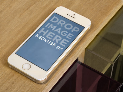 Mockup of an iPhone Placed on a Brown Table