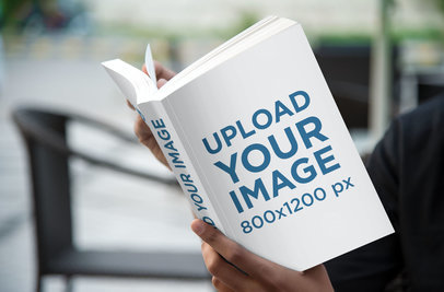 Mockup of a Young Man Reading a Digest Size Book Outside 871 el1