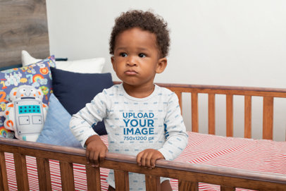 Heathered Onesie Mockup of a Baby Boy in His Crib
