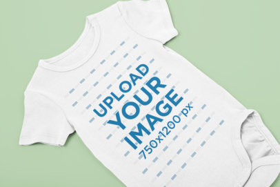 Mockup of a Onesie Placed over a Flat Surface