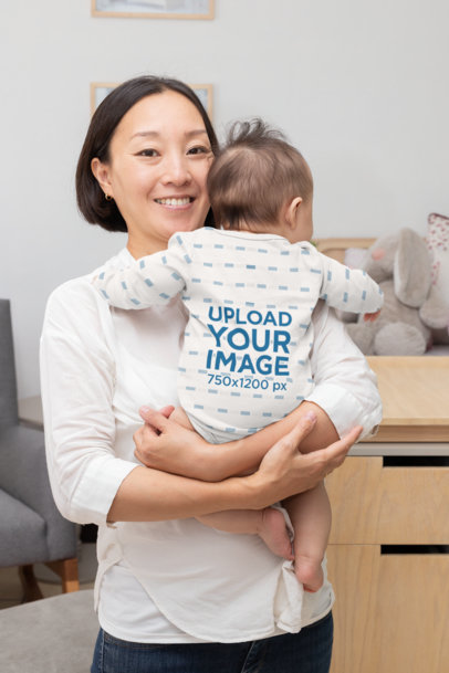 Mockup of a Mom Holding Her Baby Wearing a Onesie 