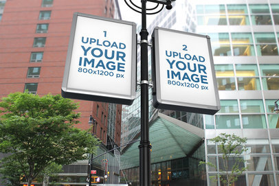 Mockup of Two MUPIs Placed on an Lamp Post Facing City Buildings
