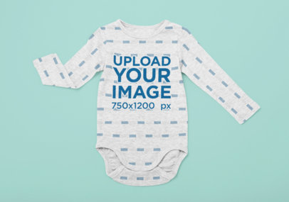 Sublimated Long Sleeve Onesie Mockup Placed over a Flat Surface