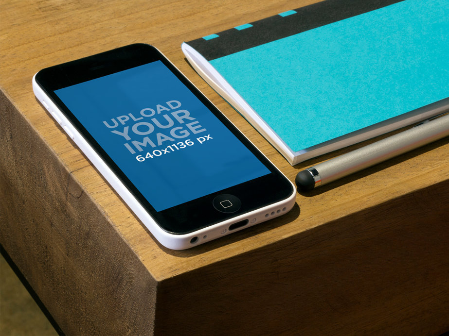 iPhone Mockup Featuring a Wooden Desk 