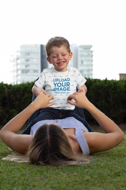 Heather Mockup of a Baby Boy Wearing a Onesie and Playing with His Mom