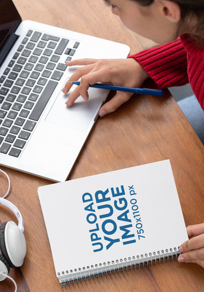 Spiral Notebook Mockup of a Woman Working on Her Desk 