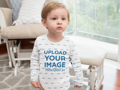 Heather Mockup of a Little Boy Wearing a Long Sleeve Onesie in a Living Room