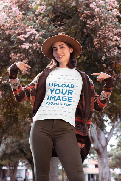 Mockup of a Stylish Woman Pointing at Her T-Shirt in Fall