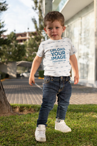 Short-Sleeve Heather Onesie Mockup Featuring a Boy Posing in the Backyard