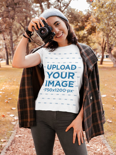 T-Shirt Mockup of a Young Woman Taking Pictures at a Park