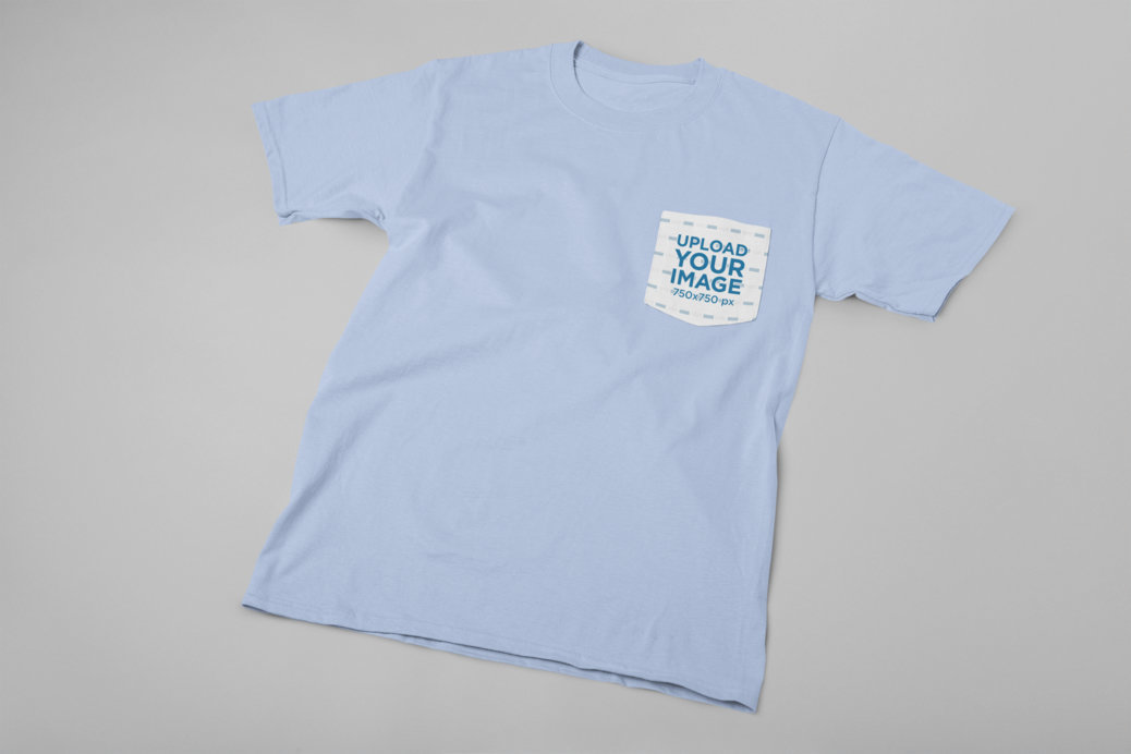 Pocket Tee Mockup Lying Flat Against a Solid Surface