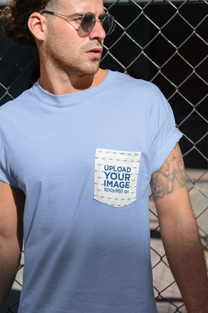 Pocket Tee Mockup of a Man Posing Against a Fence