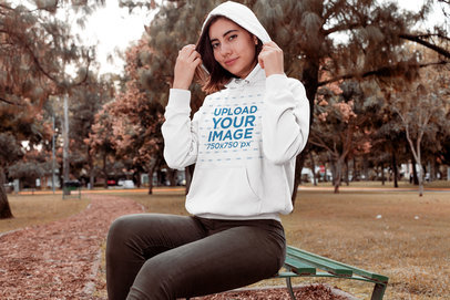 Mockup of a Woman Wearing a Pullover Hoodie at a Park
