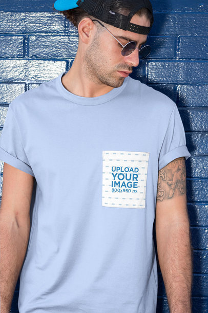 Pocket Mockup of a Man Posing Against a Brick Wall
