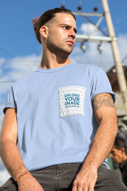 T-Shirt Pocket Mockup Featuring a Serious-Looking Man with a Tattoo