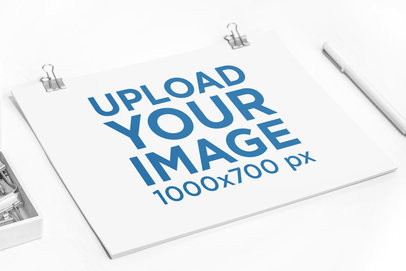 Letterhead Mockup Featuring a White Desk and Some Binder Clips 