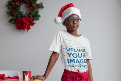 T-Shirt Mockup of a Cool Kid Wearing a Christmas Hat