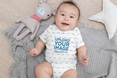 Heather Onesie Mockup of a Baby Boy Lying on Cozy Blankets 30041