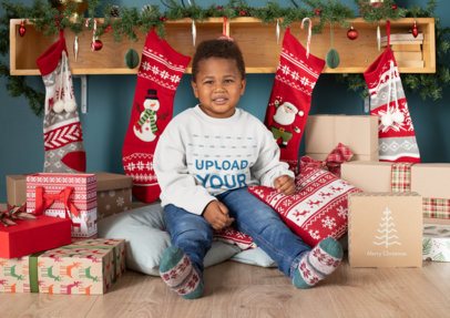 Mockup of a Boy With a Crewneck Sweatshirt Surrounded by Christmas Presents 