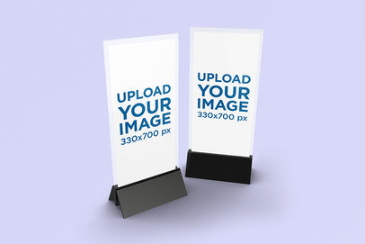 Mockup Featuring Two Table Tents Standing Against a Solid Color Backdrop