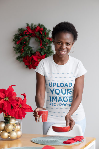 Mockup of a Woman with a Customizable T-Shirt at a Christmas Dinner