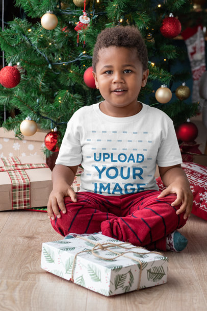 T-Shirt Mockup of a Young Boy Ready to Open His Christmas Present