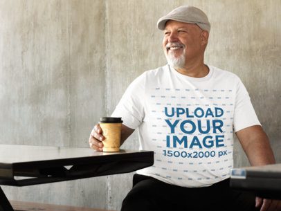 T-Shirt Mockup of an Elder Man Sitting in an Outside Space