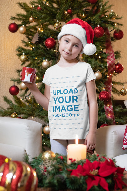 Christmas T-Shirt Mockup Featuring a Little Girl Having Hot Cocoa 