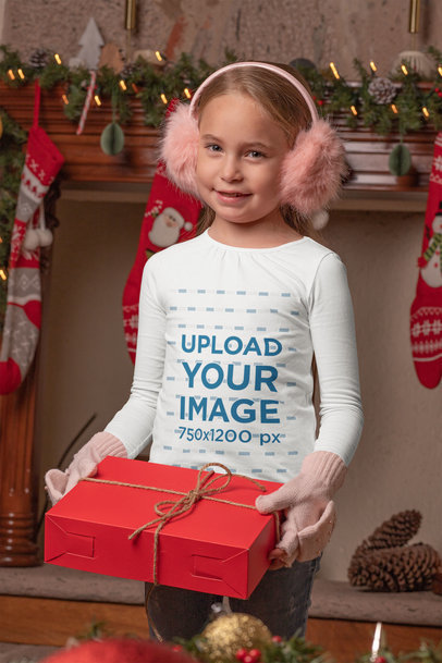 Mockup of a Girl Wearing a Long Sleeve Tee While Holding a Christmas Present 
