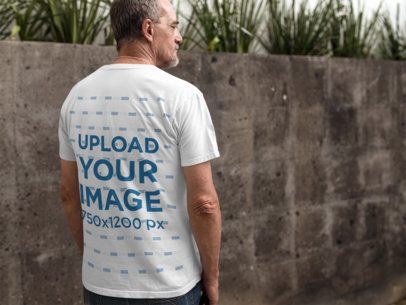 Middle Aged Man Wearing a T-Shirt Mockup from the Back in a Urban Space