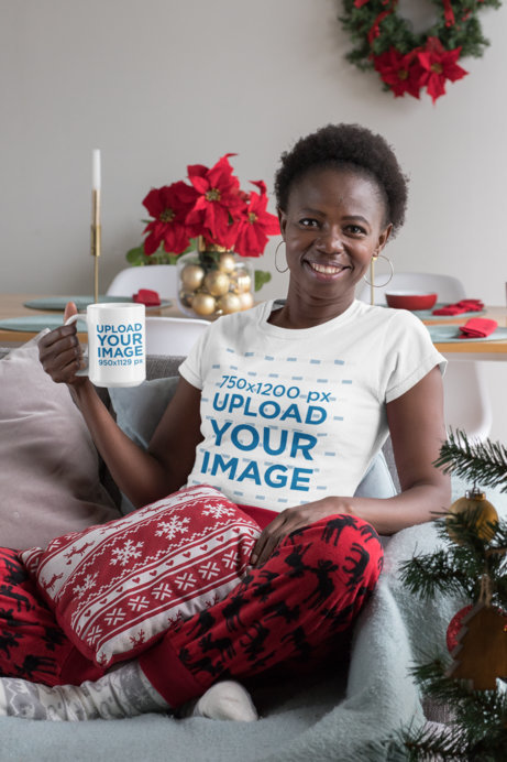 T-Shirt Mockup of a Woman Holding a 15 oz Coffee Mug at a Christmas Decorated Living Room