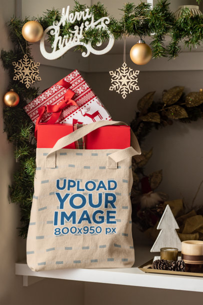 Mockup Featuring a Tote Bag Placed on a Shelf near Some Christmas Decorations